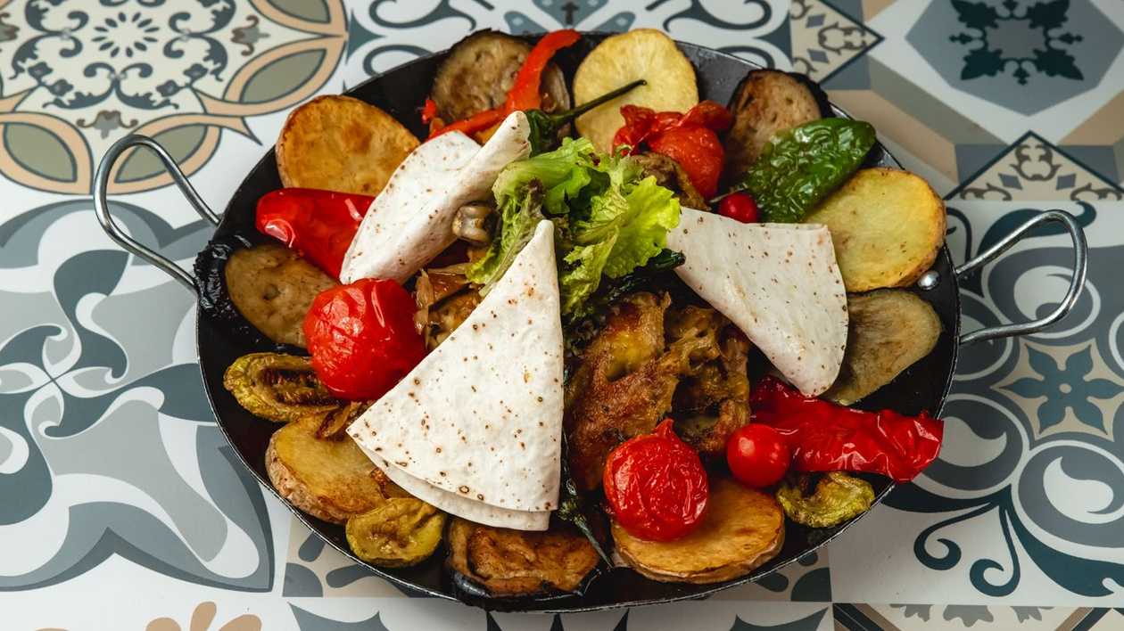 Village Style Grilled Meat on a Metal Plate
