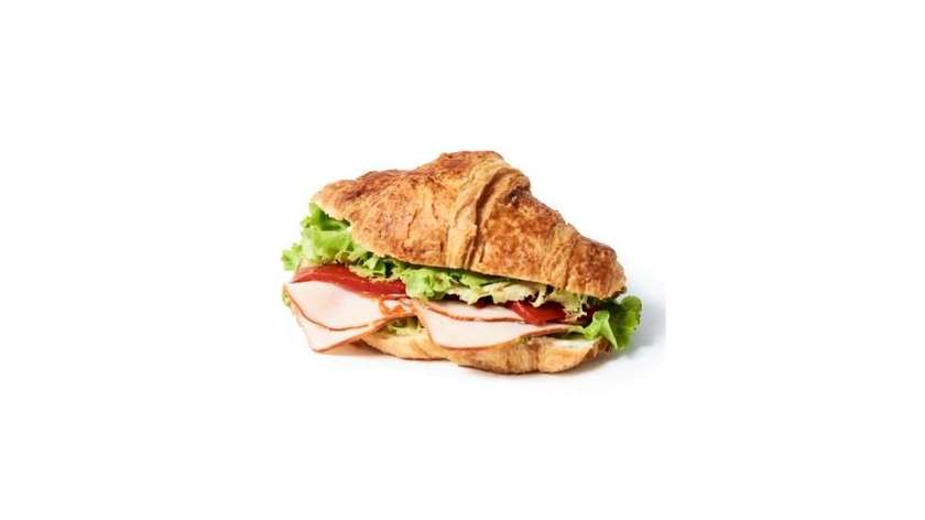 Croissant with marinated roasted pepper, ham, and cream cheese