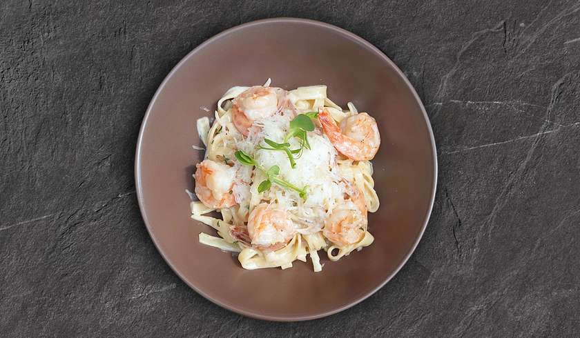 Tagliatelle pasta with tiger prawns in a creamy sauce.