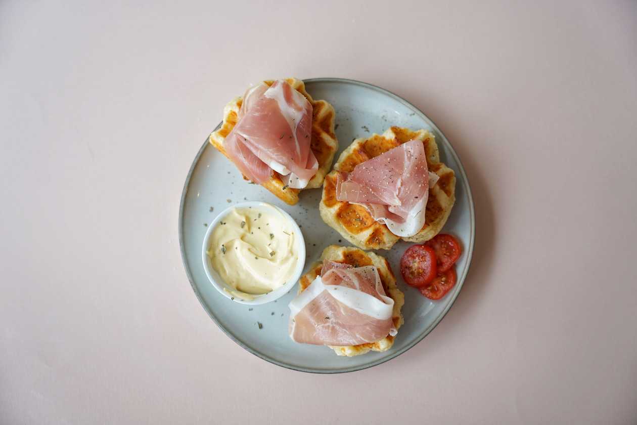 Cheese waffle bites with prosciutto and aioli sauce