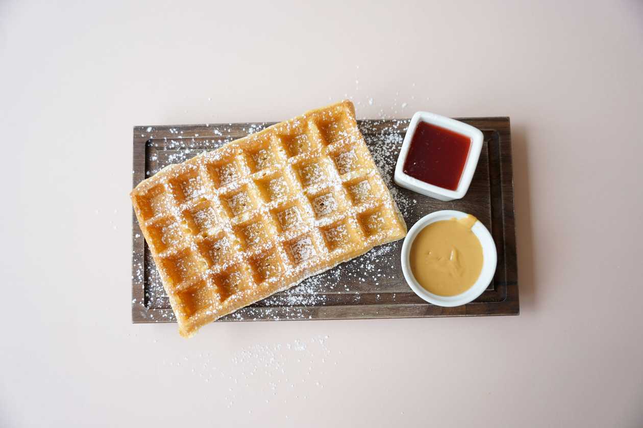 Brussels waffle with peanut butter and strawberry jam