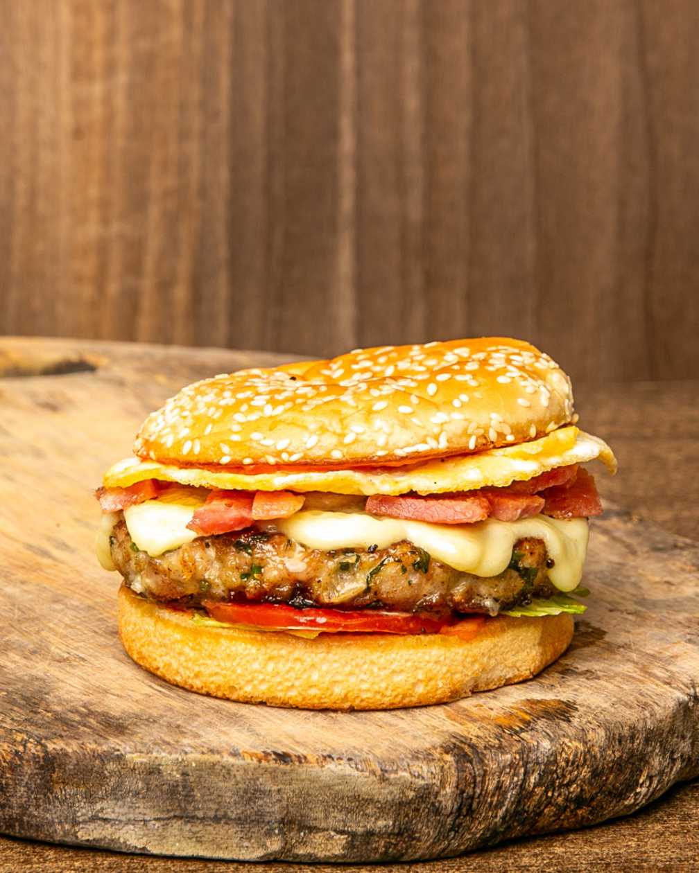 Chicken, bacon, egg and cheese burger with fries
