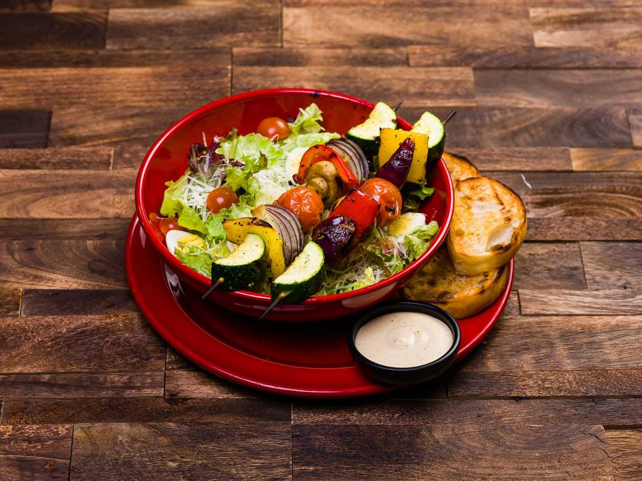 Ceasar salad with skewered vegetables midle