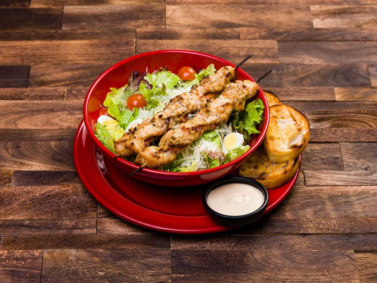 Ceasar salad with turkey breast skewer midle
