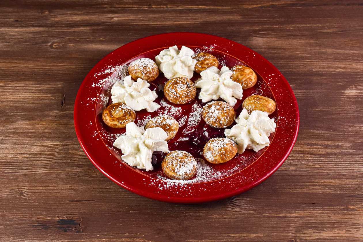 Mini pancakes with cherry jam and whipped cream