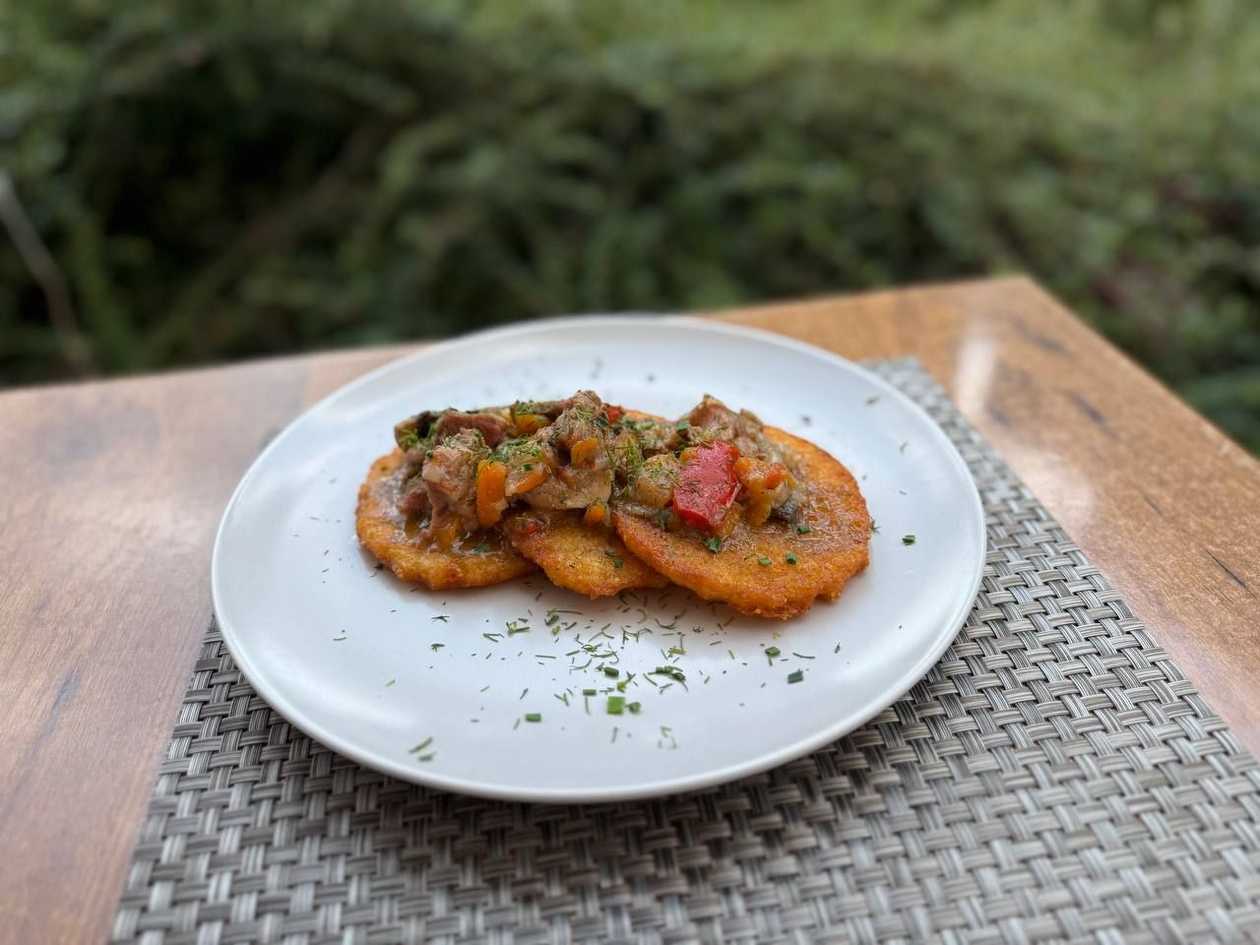 Potato pancakes with fried pork and onion