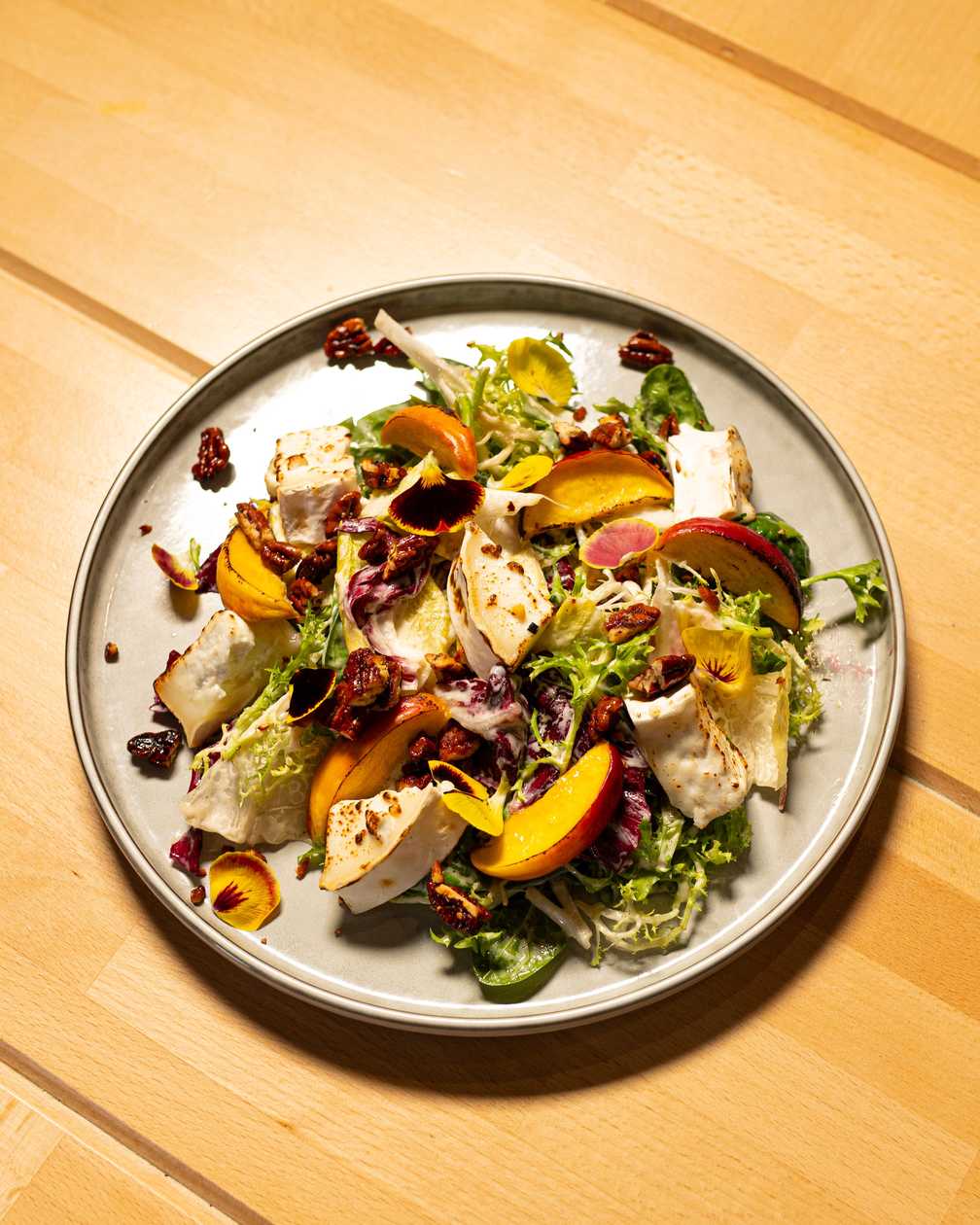 Salad with goat cheese, nuts, nectarine, honey-lime vinaigrette