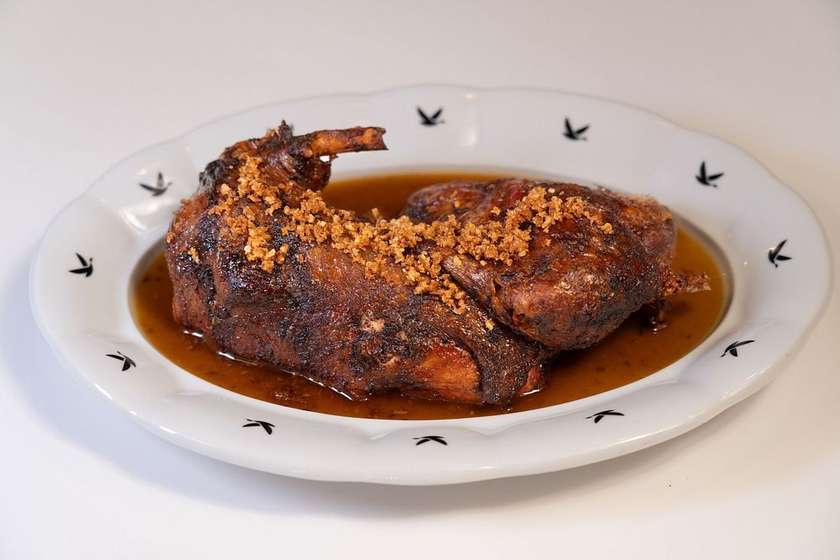 Half a duck grilled over charcoal, rich duck jus