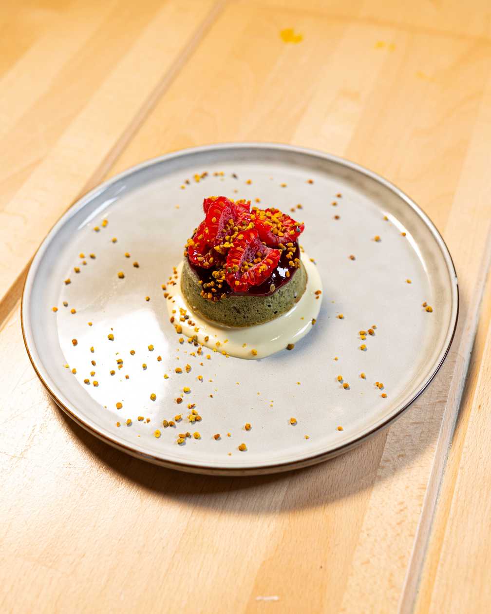 Pistachio cake, raspberries, white chocolate, bee pollen