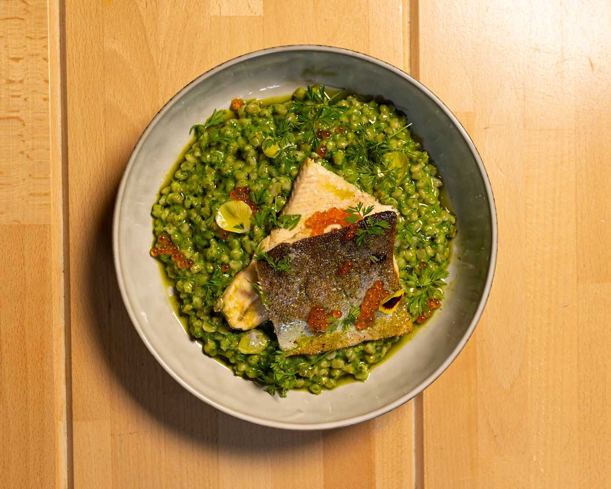 Grilled trout, spinach barleys grouts, caviar from trout, asparagus