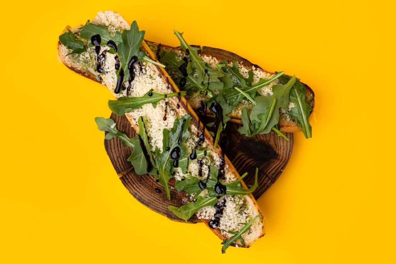 Grilled ciabatta with garlic butter, cheese and arugula fresh
