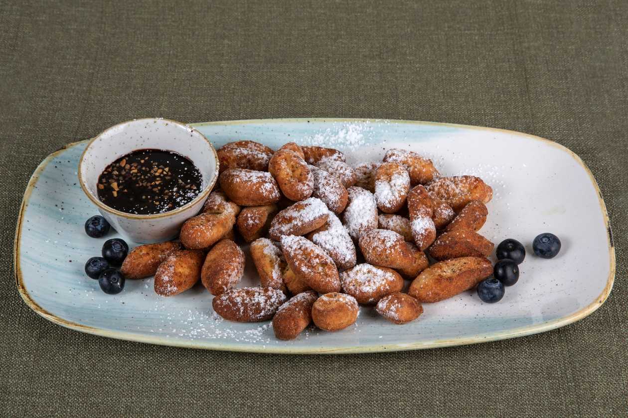 Deep-fried curd dumplings with chocolate and caramelised peanuts