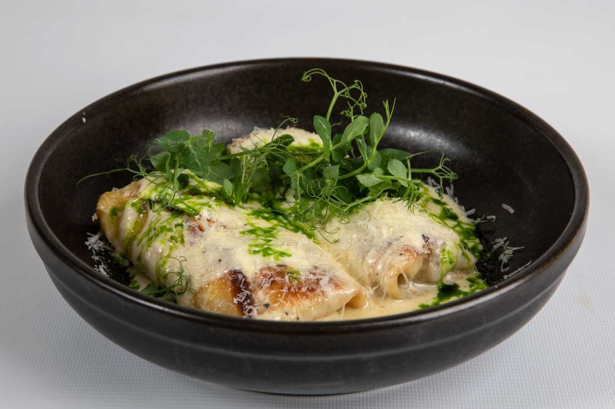 Crepes with ham and cheese in cream sauce