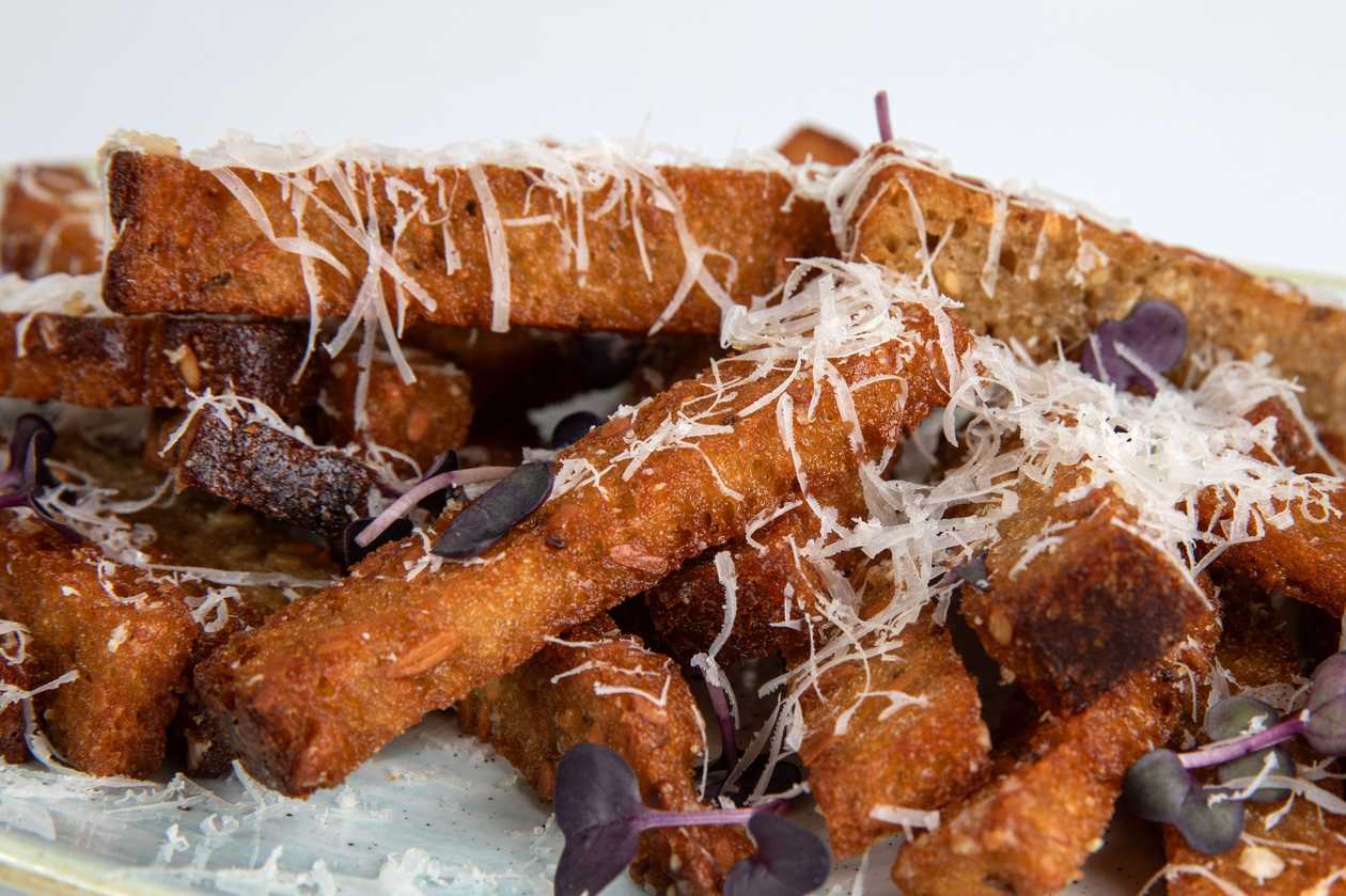 Fried bread strips with cheese sauce