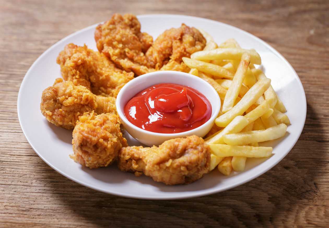 Fried chicken pieces with french fries and ketchup
