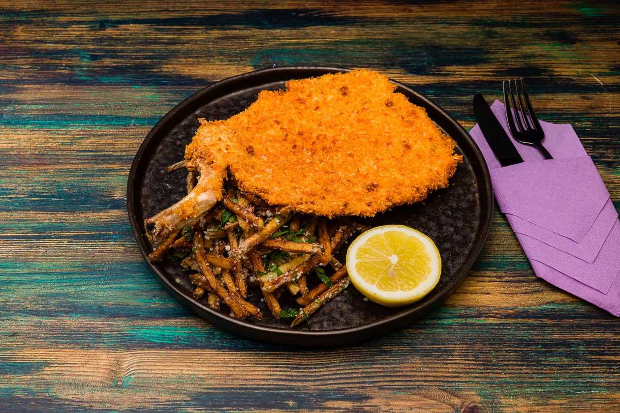 Cowboy schnitzel with French fries and grated cheese