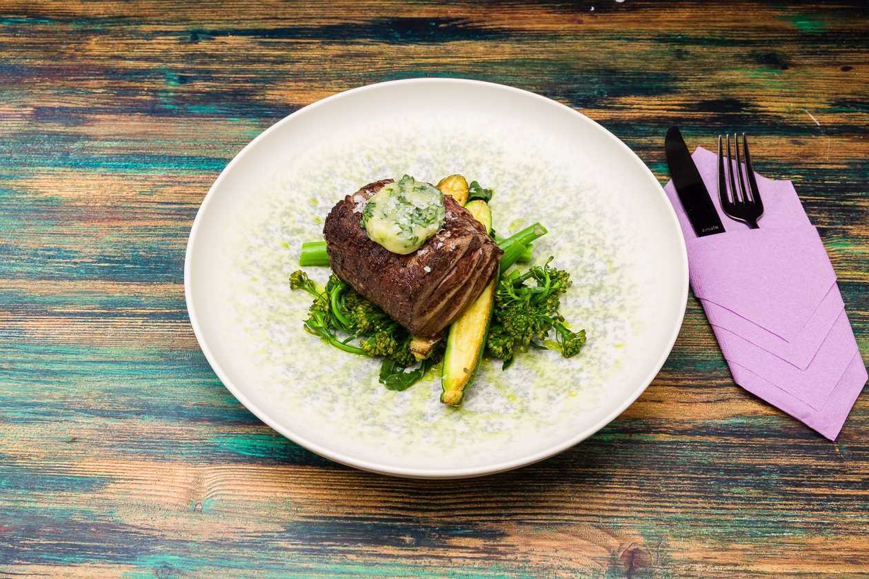 Beef tenderloin with flavored butter and baby vegetables