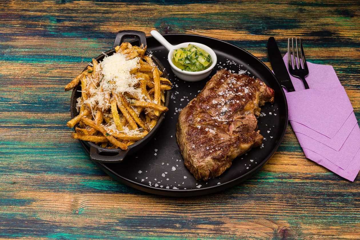 Steak and fries with flavored butter