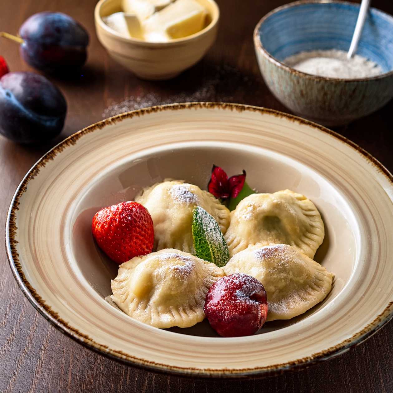 Dumplings filled with plums or strawberries with butter and sugar