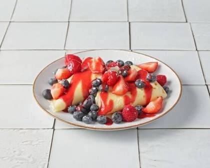Pancakes with forest fruits and whipped cream