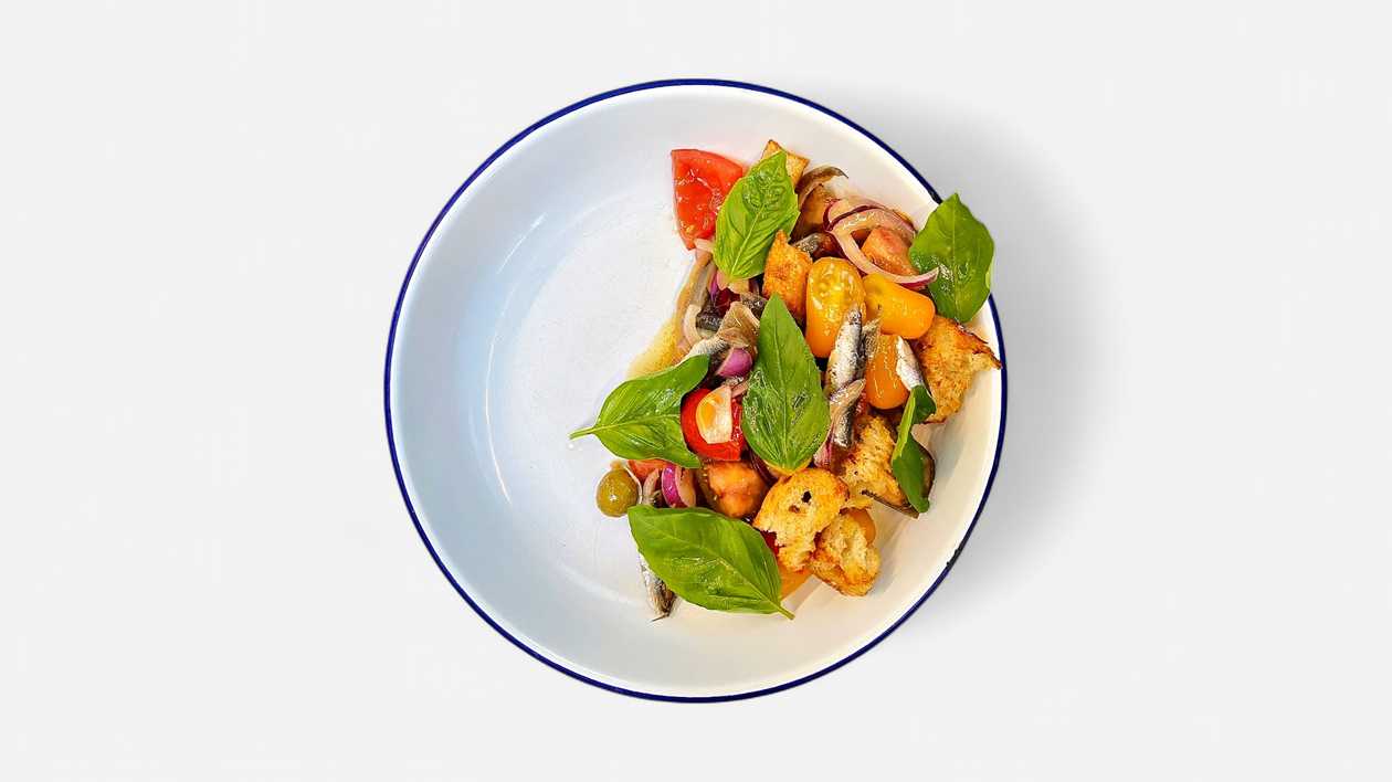 "Fisherman's" salad with tomato. anchovy fillet and croutons