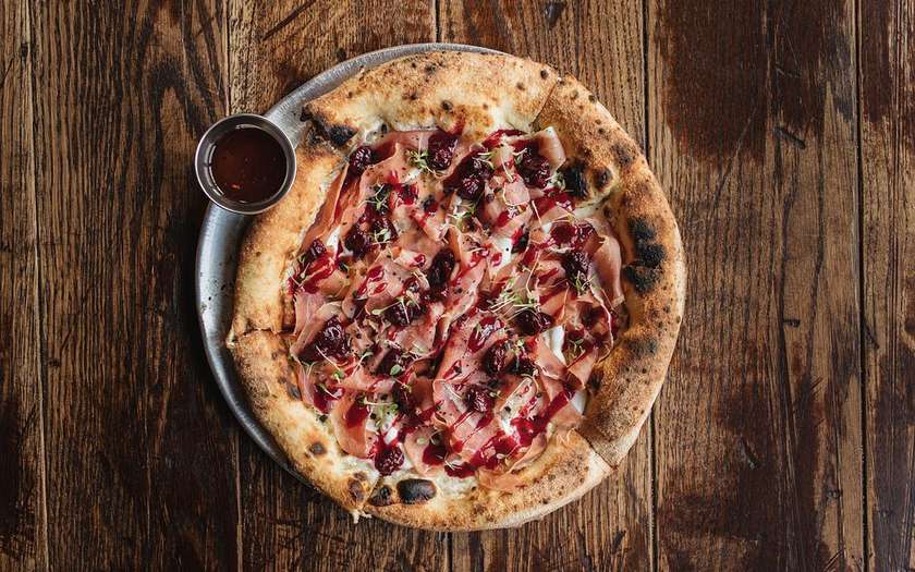 Pizza with parma and dried cherries in porto