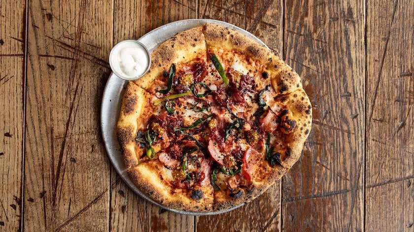 Pizza with crispy bacon and caramelized onions