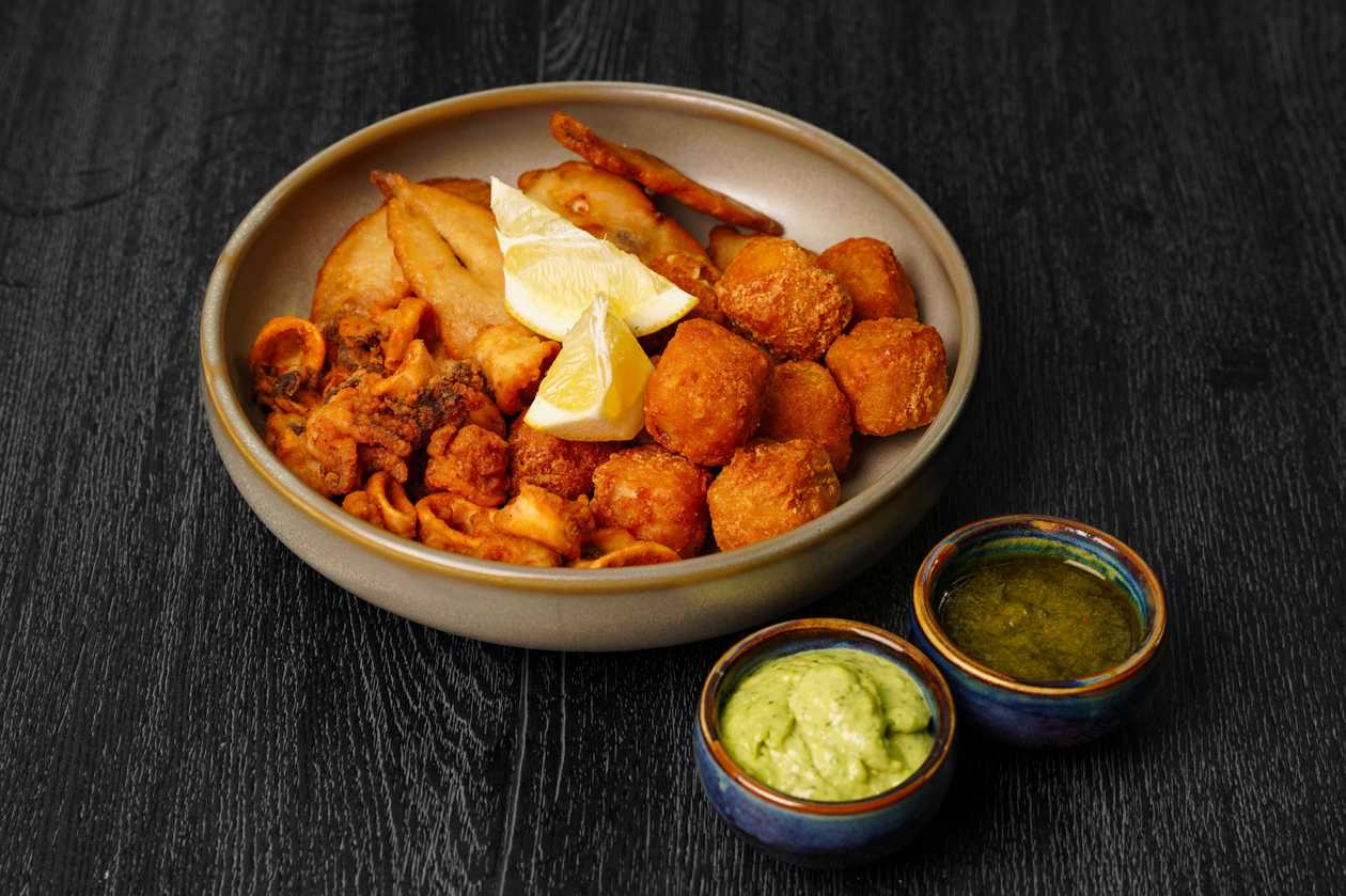 Crispy seafood platter with kale - jalapeno salsa and parmesan sauce