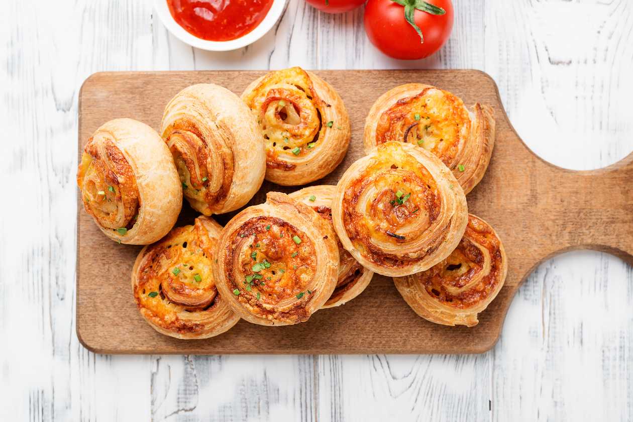 Pizza rolls stuffed with ham and cheese, garlic sauce