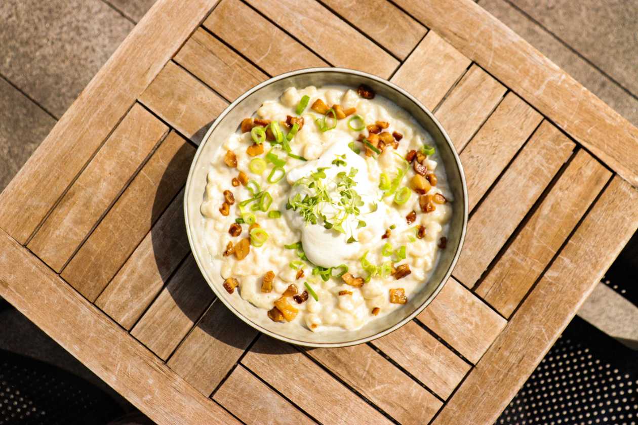 Homemade dumplings with goat cheese (bryndza), pork scratchings, spring onions