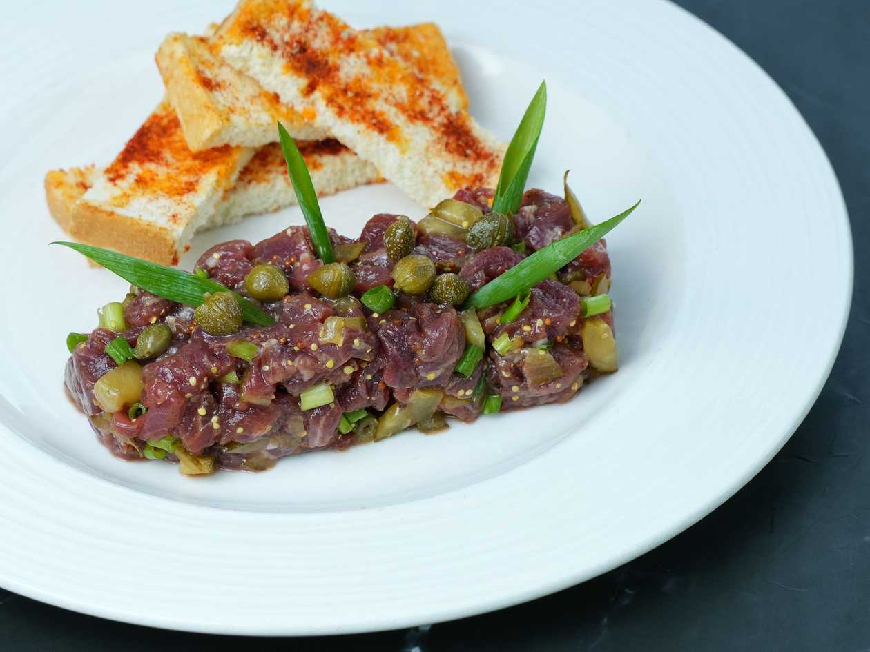 Veal tartare with pickled cucumber, onion and sun-dried tomatoes