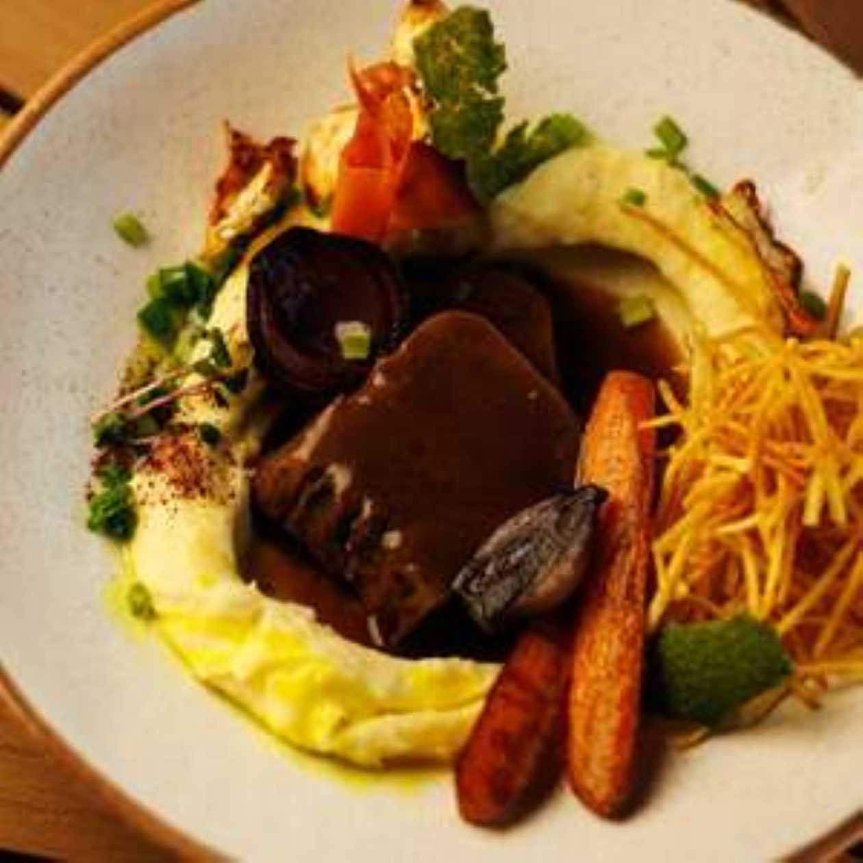 Veal tongue with mashed potatoes, root vegetables and Demi-glace sauce