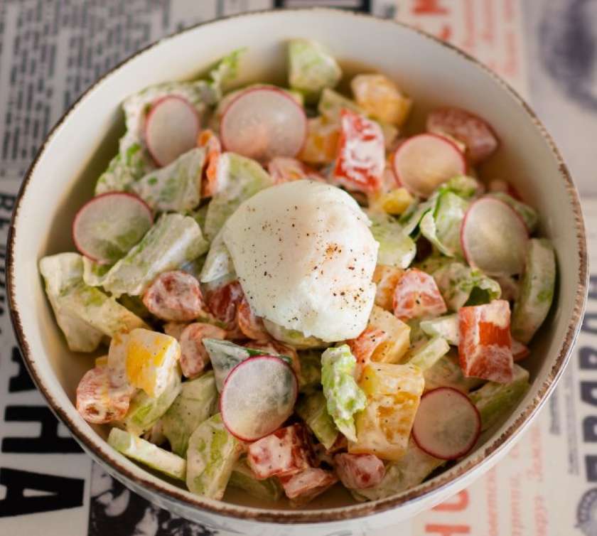 Village salad with egg and sour cream