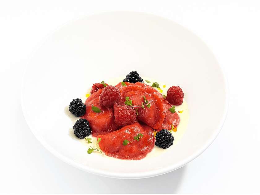 Dumplings with cherry, seasonal berry and creamy vanilla sauce