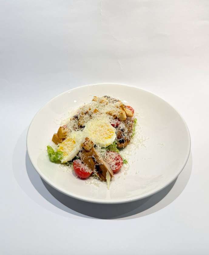 Caesar salad with chicken fillet in bacon