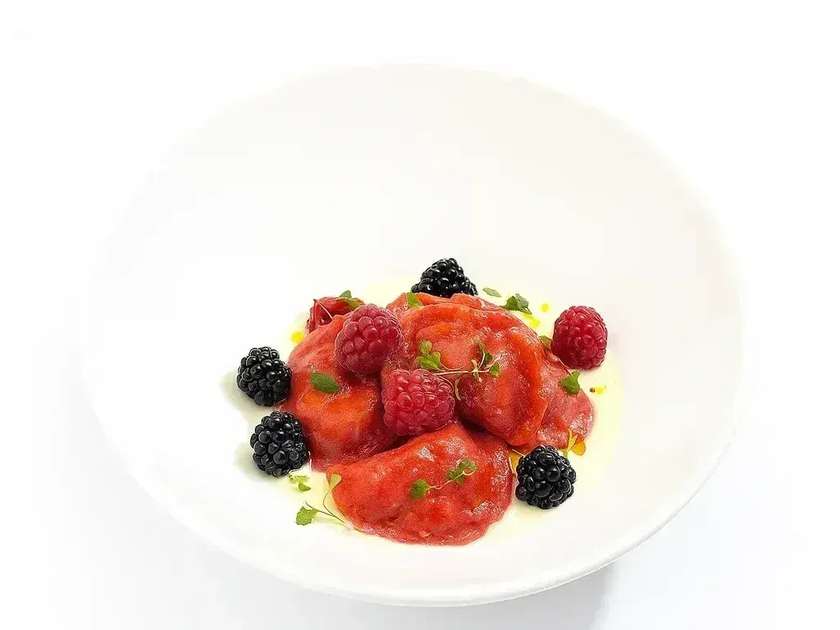 Dumplings with cherry, seasonal berry and creamy vanilla sauce.