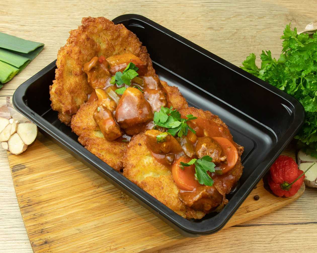 Spicy meat strips in a potato pancake