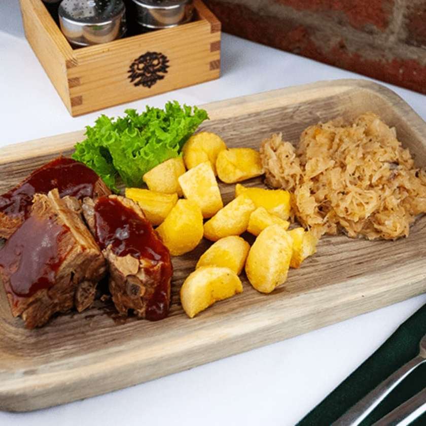 Ribs roasted in honey, fried potatoes & fried cabbage