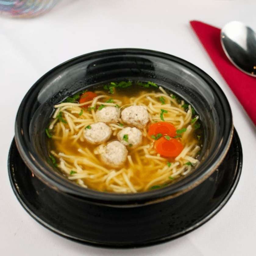 Chicken broth served with pork meatballs & noodles