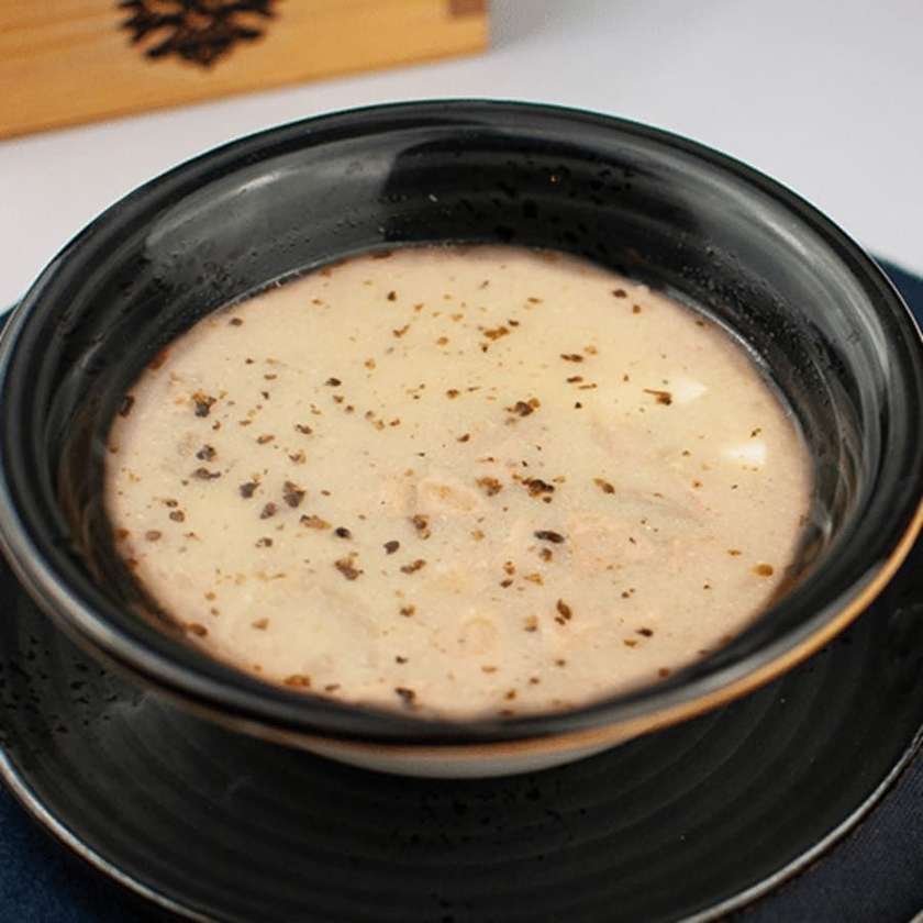 Sour rye soup served with egg, sausage & potatoes