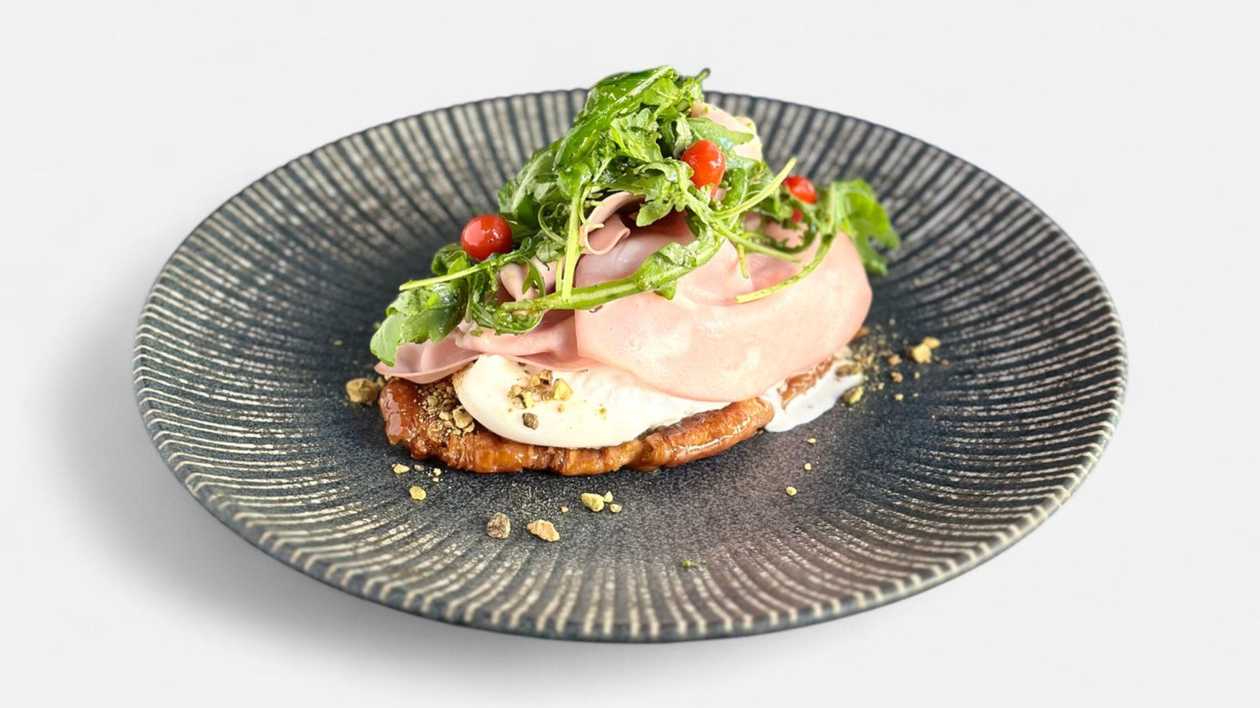 Burrata cheese and mortadella on caramelized croissant