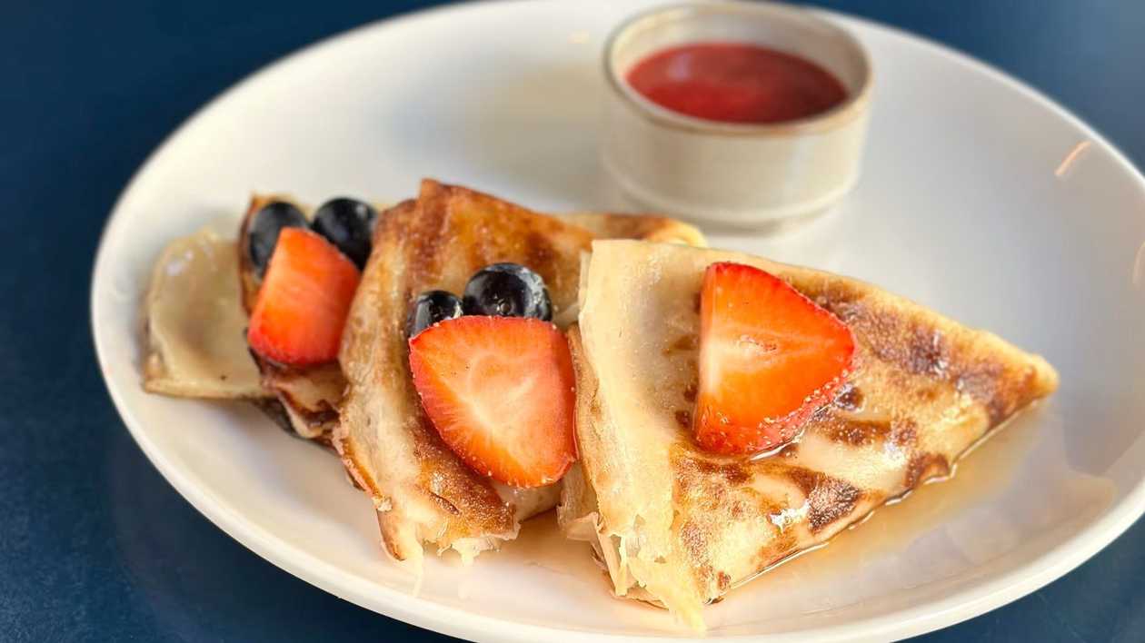 Thin pancakes with fresh berries and jam