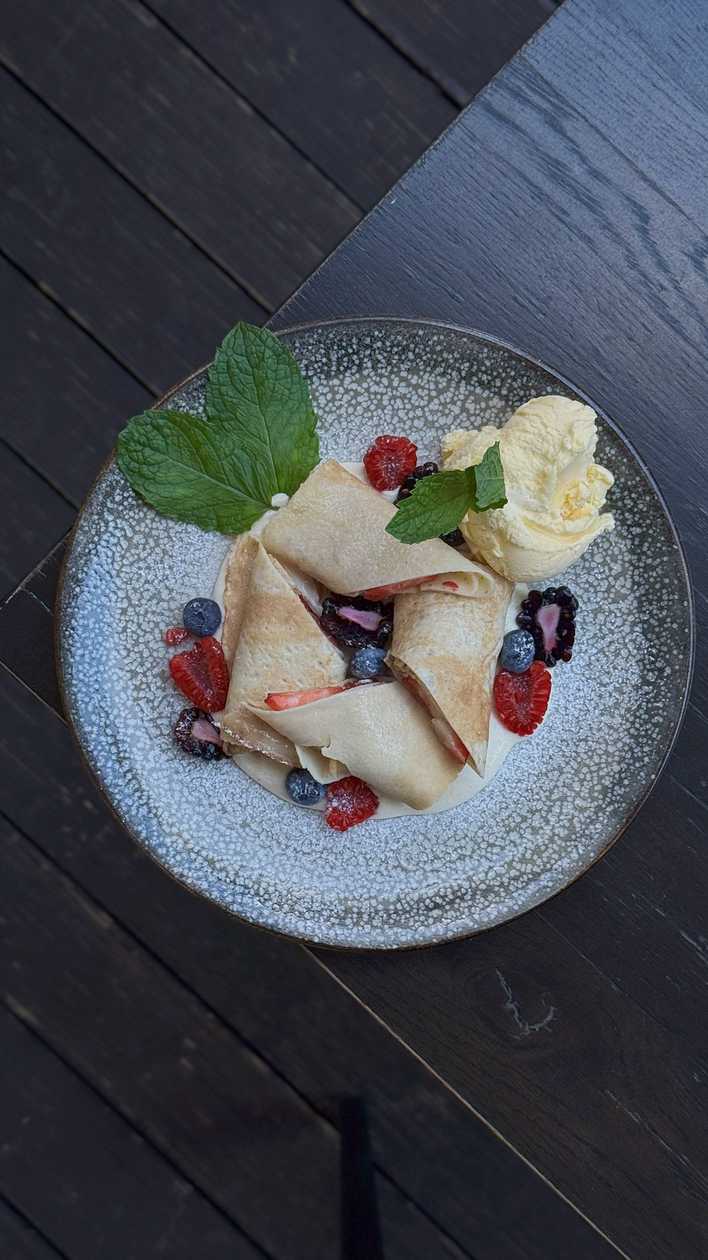 Crepes in creamy sauce with berries