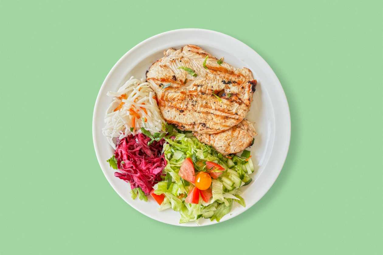 Grilled chicken steak with a side dish of your choice, salad and dressing.