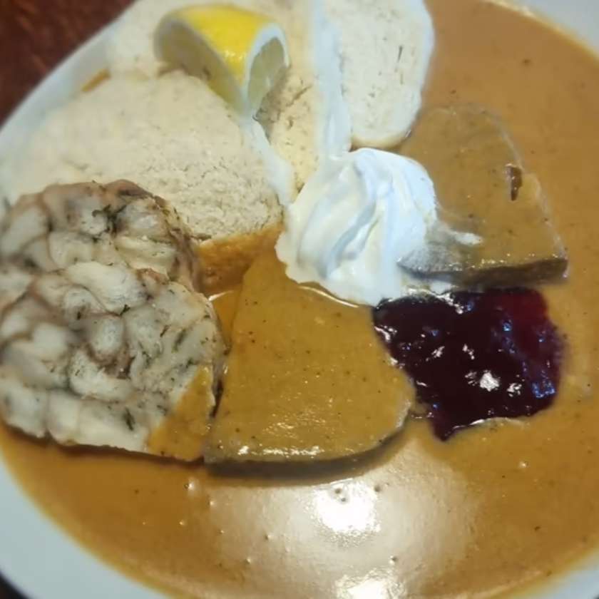 Tenderloin in Cream with Bread Dumplings, Cranberries and Whipped Cream