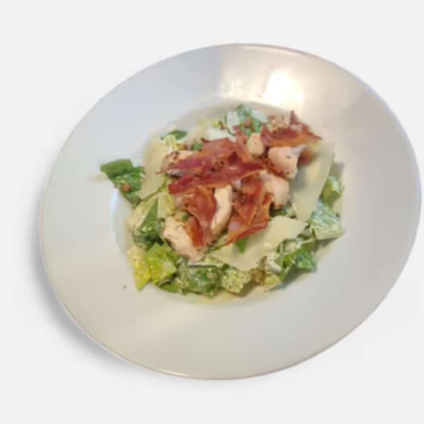 Caesar Salad – Romaine Lettuce Leaves with Anchovy Dressing, Chicken, Herbed Croutons, Roasted Bacon and Parmesan Shavings