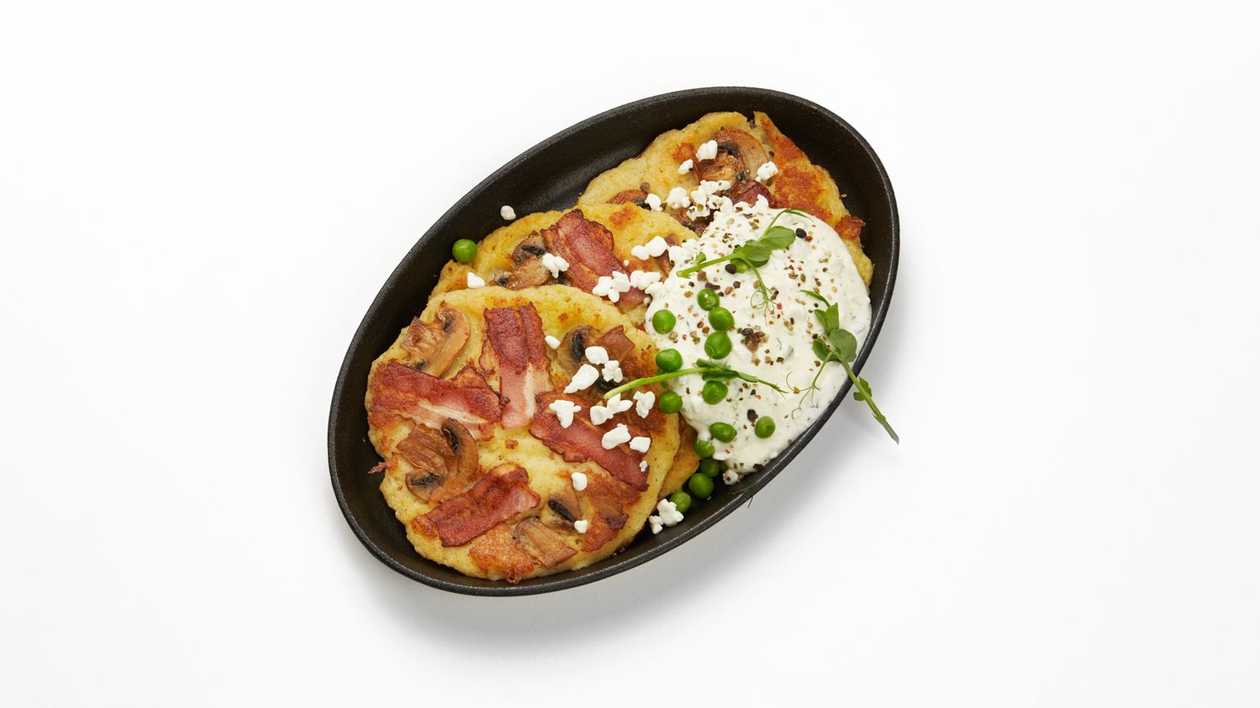 Potato pancakes with bacon and champignons