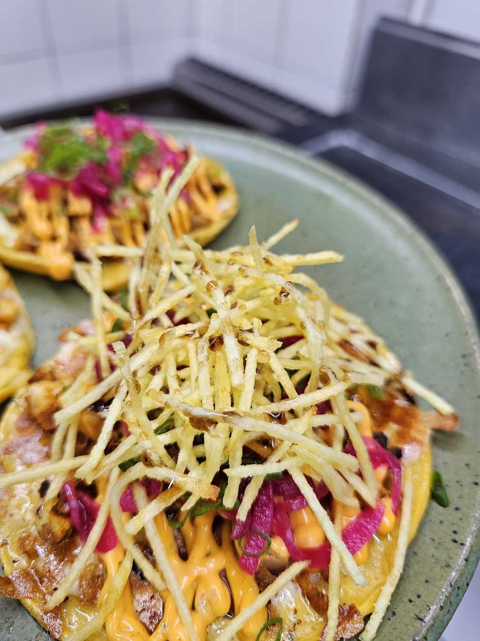 Tacos with fish and sauce with chipotle peppers and caramelized onions