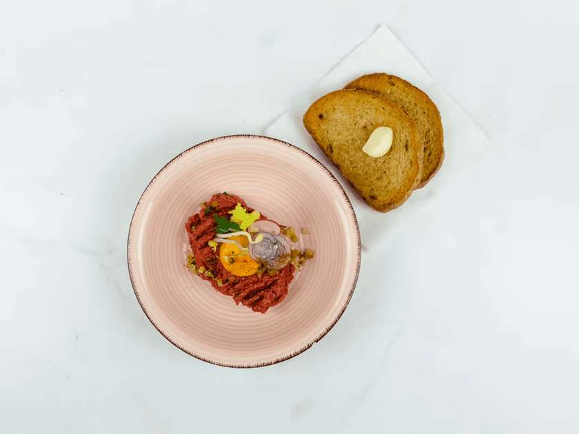 Traditional beef tartare with toast and garlic