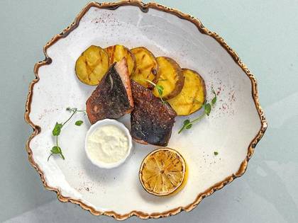 Catfish with baked potatoes and cream sauce